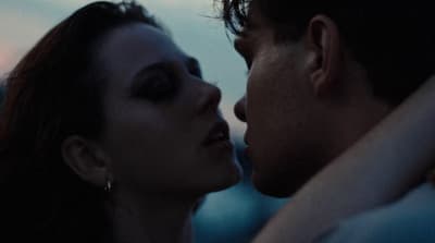 a man and a woman kissing each other