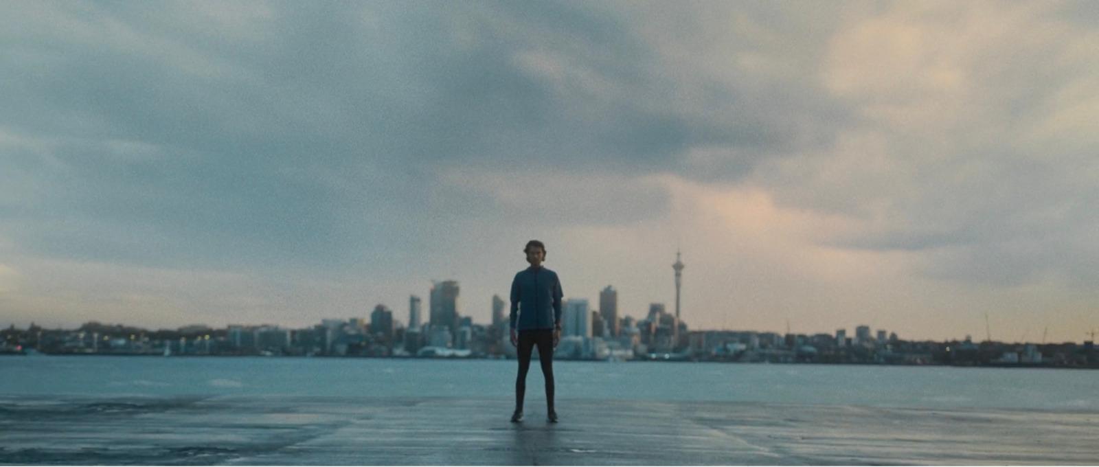 a man standing on top of a pier next to a large body of water
