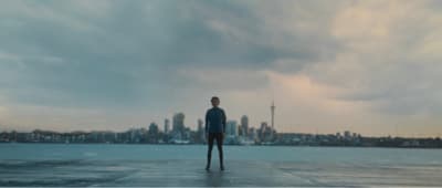 a man standing on top of a pier next to a large body of water