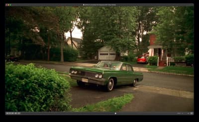 a green car parked on the side of the road