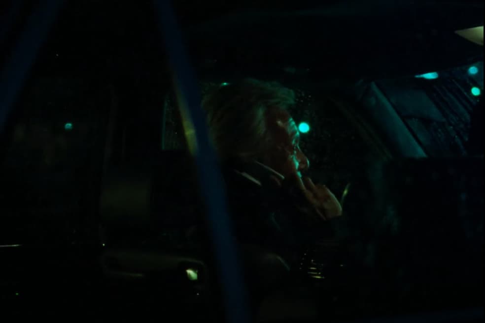 a woman sitting in a car talking on a cell phone