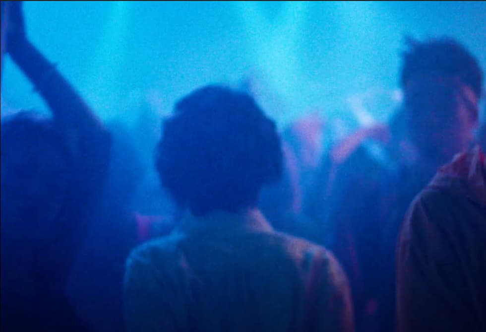 a group of people standing around in a room
