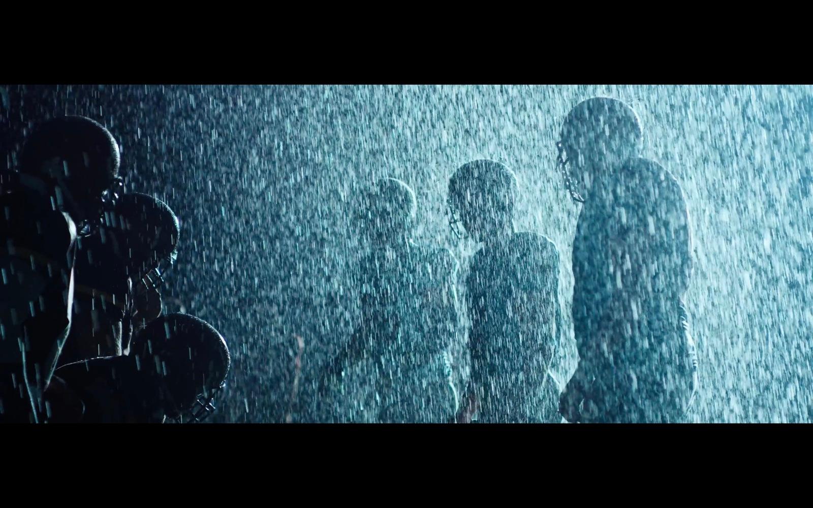 a group of people standing in the rain