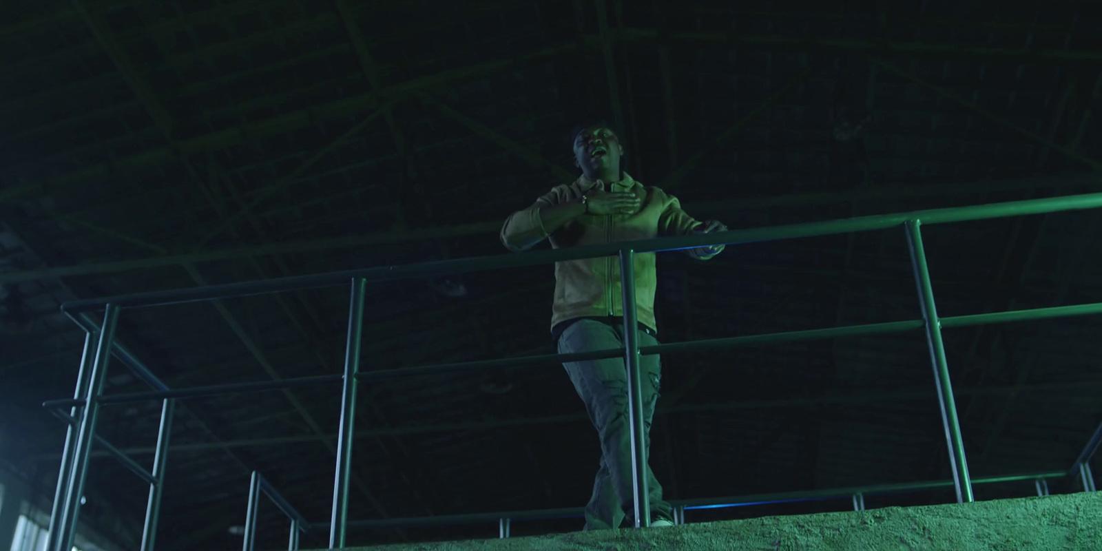 a man standing on a railing in a building