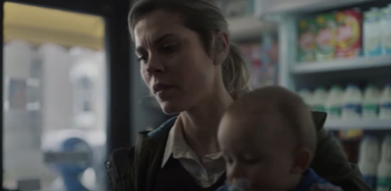 a woman holding a baby in her arms