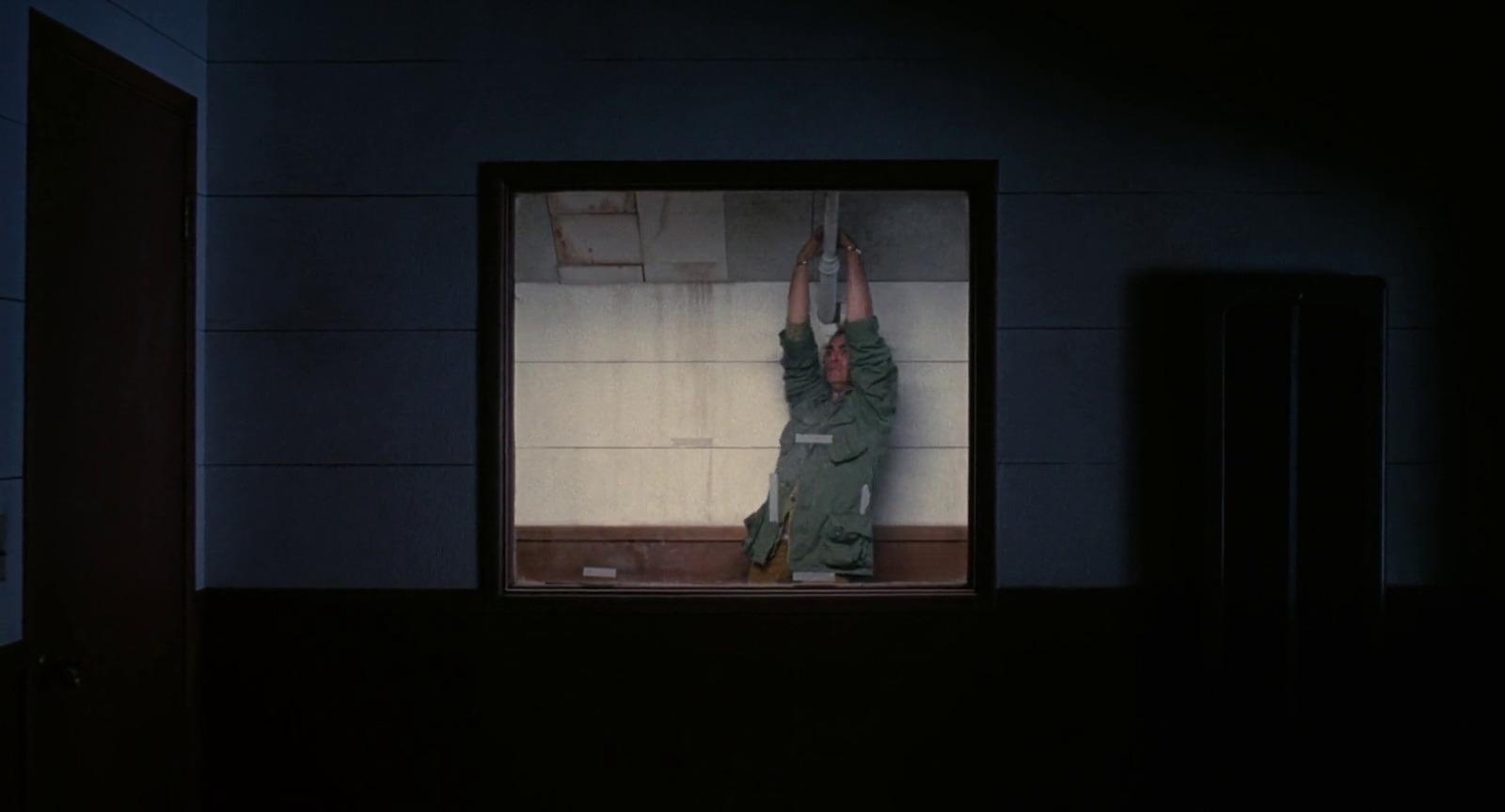 a person standing in a room with their hands in the air
