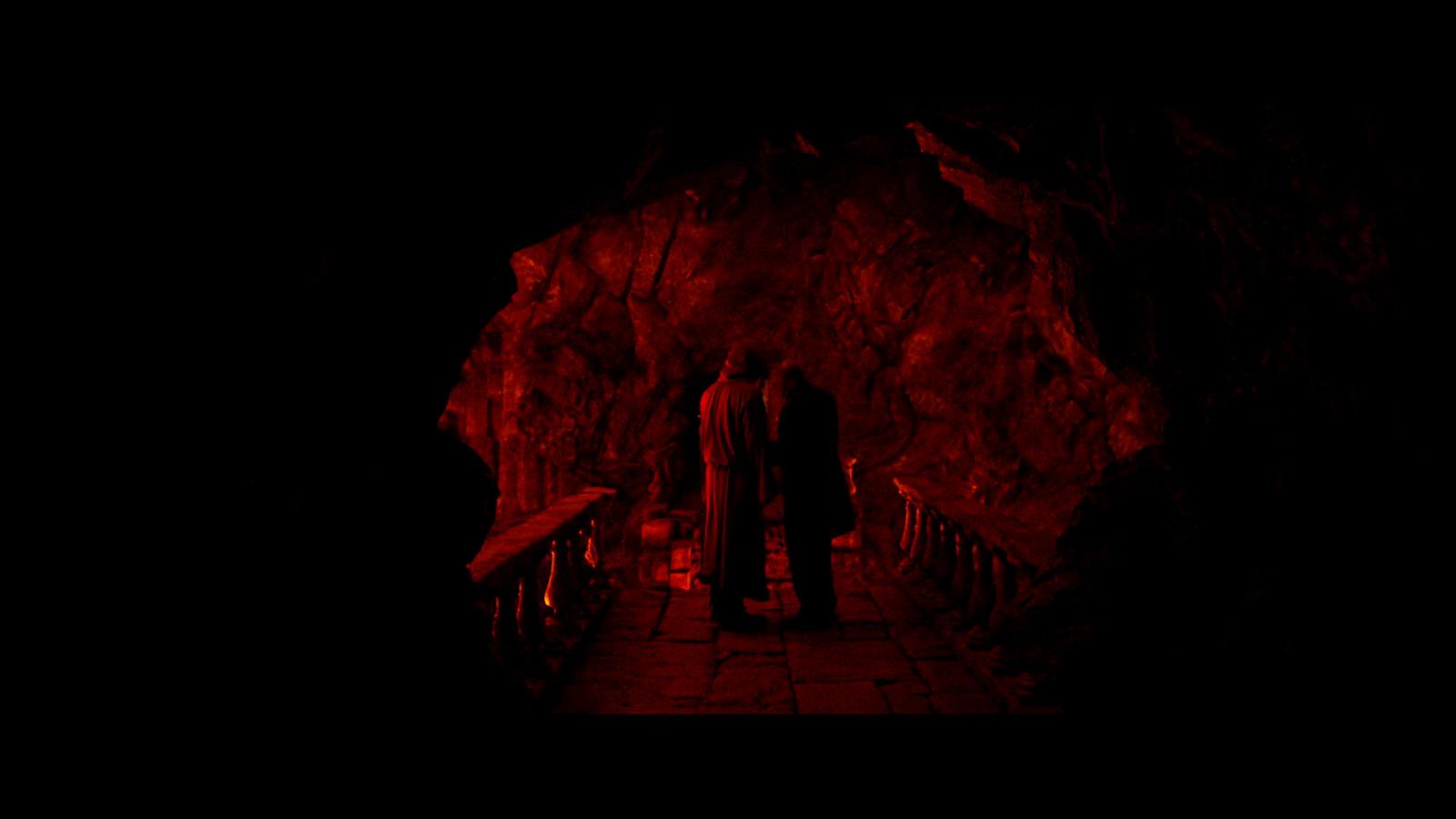 a couple of people that are standing in the dark