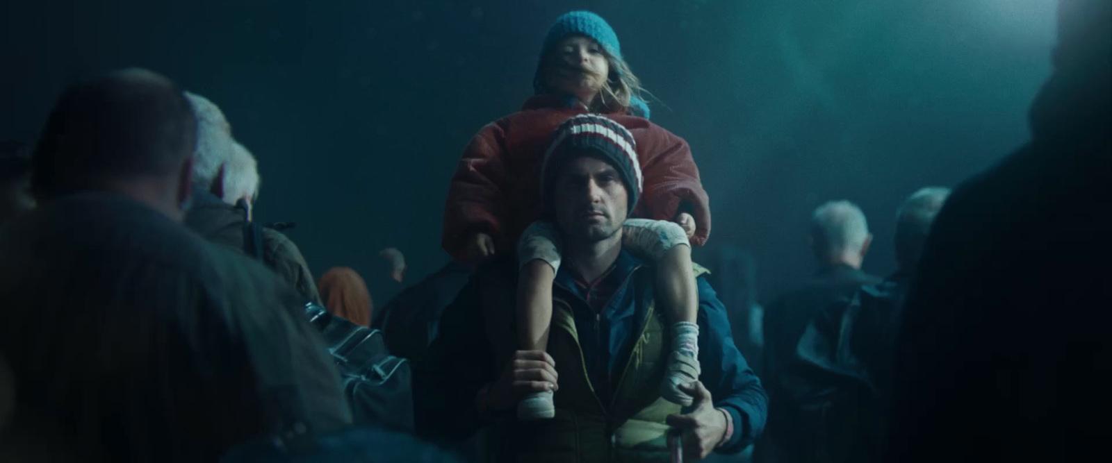 a man holding a child in a crowd of people