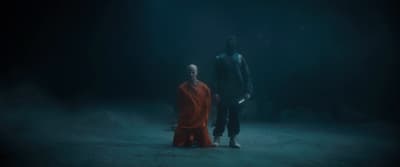two people standing in a dark room