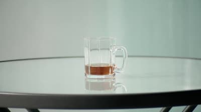 a glass of tea sits on a table