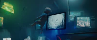 a blurry image of a person standing in front of a monitor