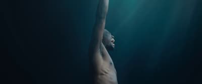 a man with his arms up in the water