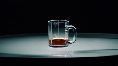 a glass mug with a liquid inside of it