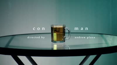 a glass of beer sitting on top of a table