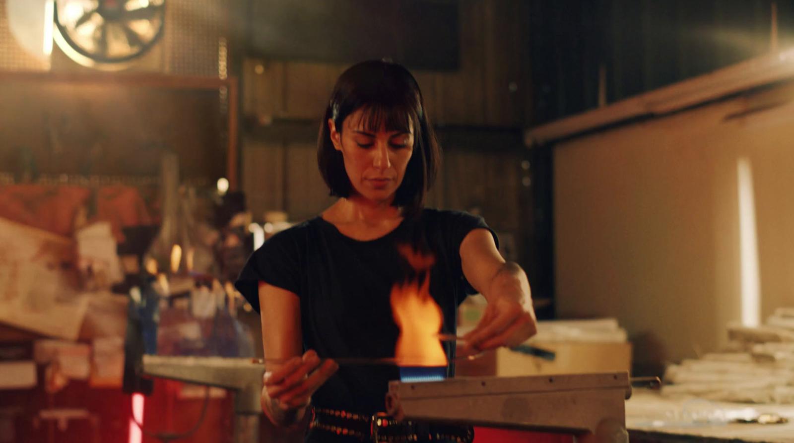 a woman standing in a kitchen preparing food