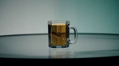 a glass of tea sitting on top of a table
