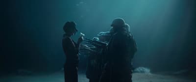 a couple of people standing in a dark room