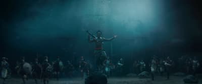 a man standing on top of a stage surrounded by people