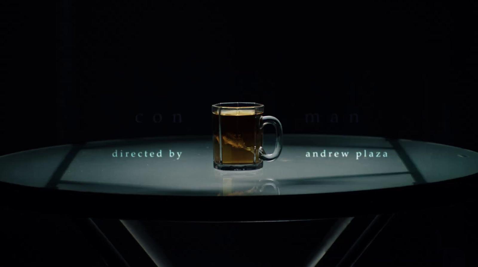 a glass of beer sitting on top of a table