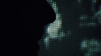 a blurry image of a person with a cell phone