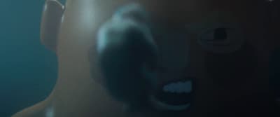 a close up of a person's face with a toothbrush in their mouth