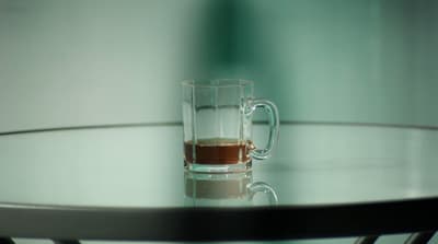 a glass of liquid sitting on top of a table