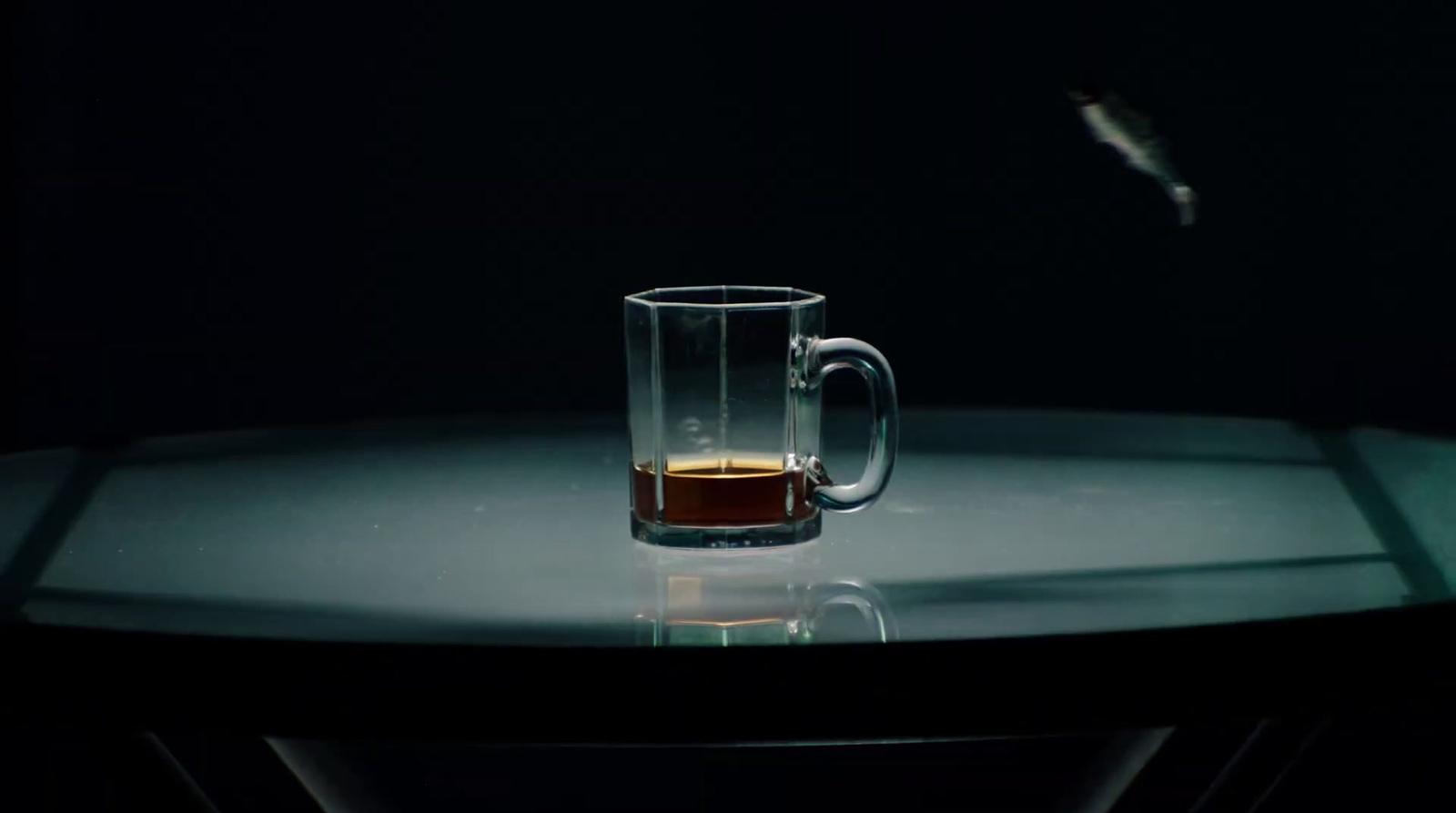 a glass of liquid sitting on top of a table