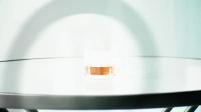 a glass of liquid sitting on top of a table