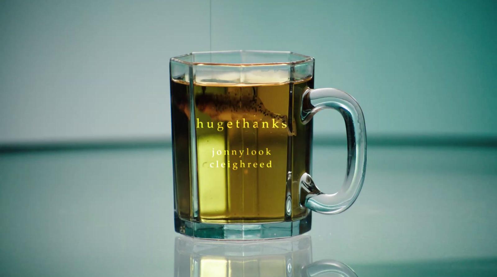 a glass mug of tea on a reflective surface