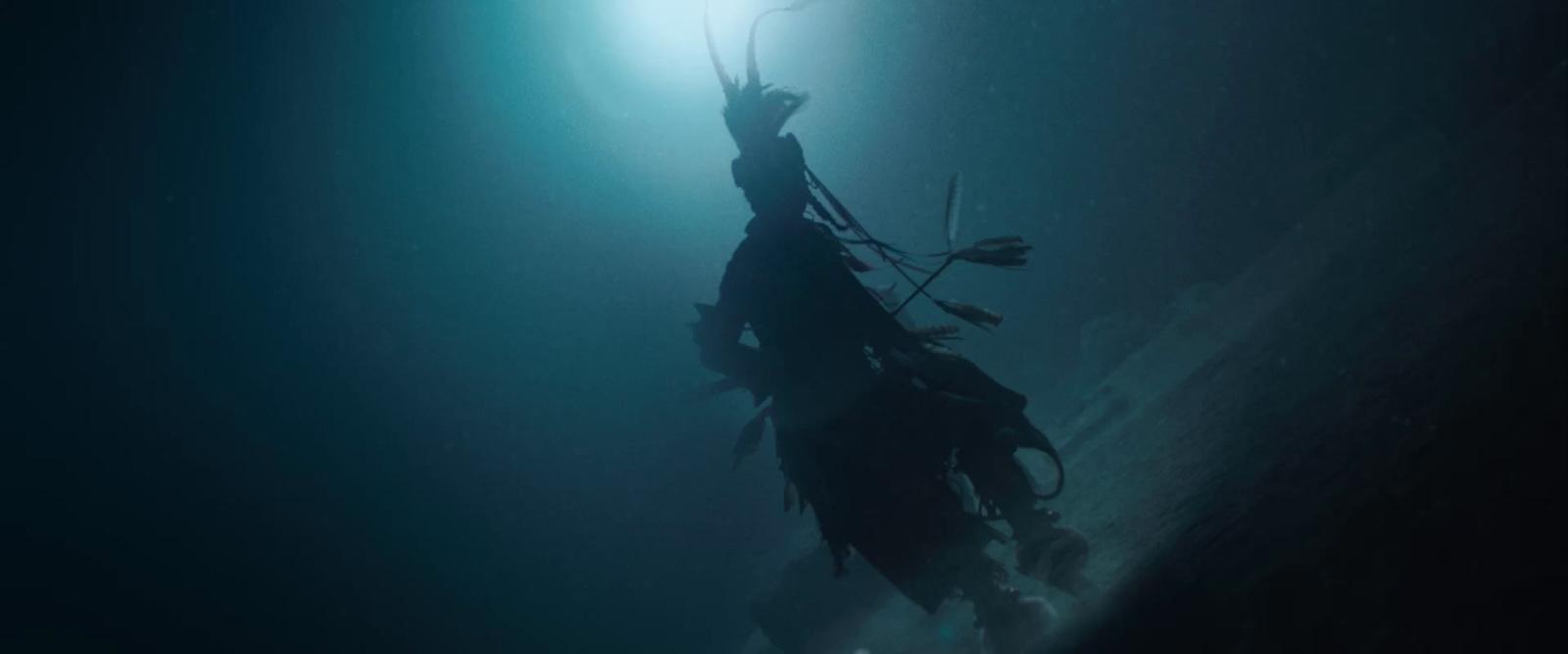 a person floating in the water with a light shining on them
