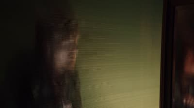 a blurry photo of a woman's reflection in a bathroom mirror
