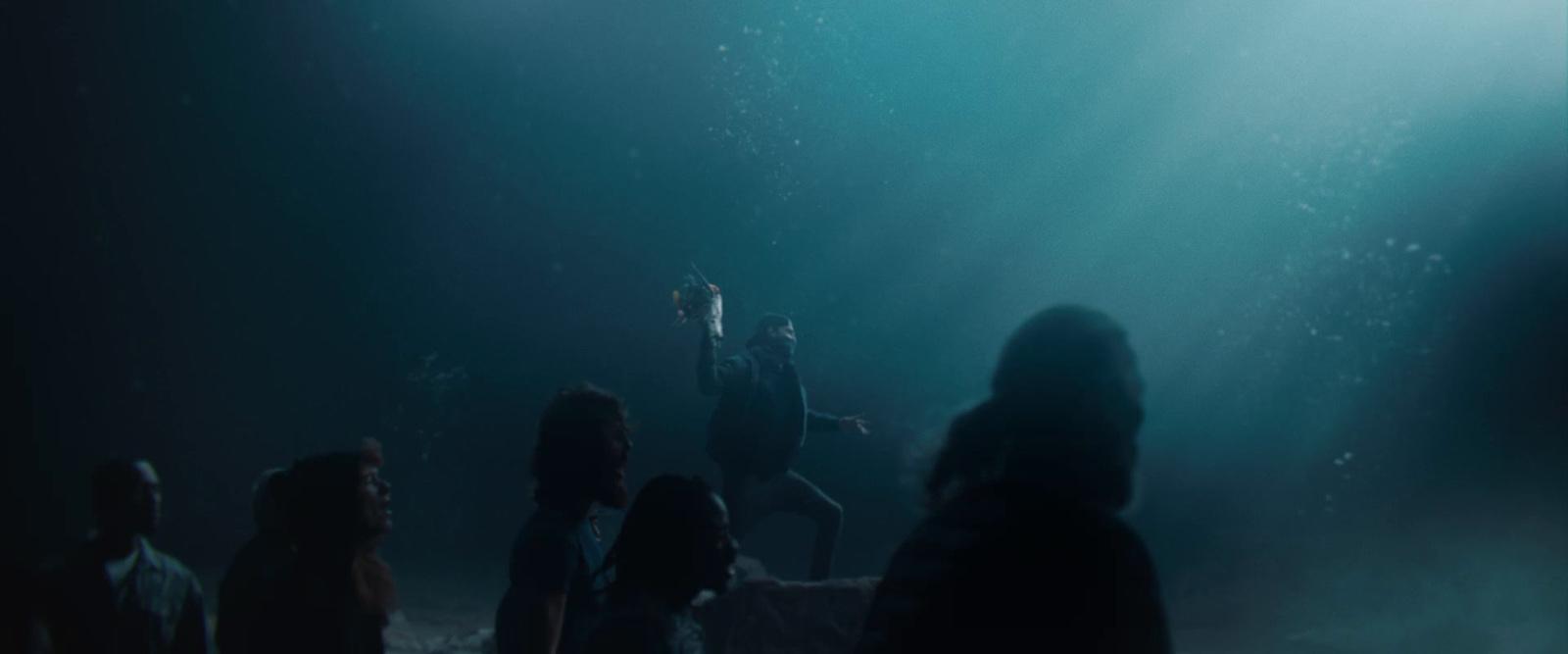 a group of people standing in a dark room
