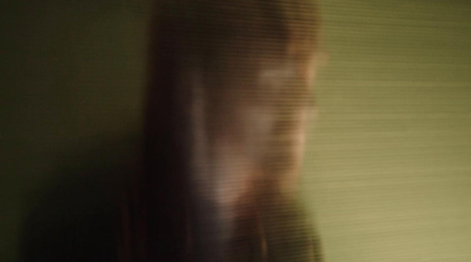 a blurry photo of a woman holding a cell phone