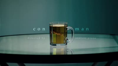 a glass of tea sitting on top of a table