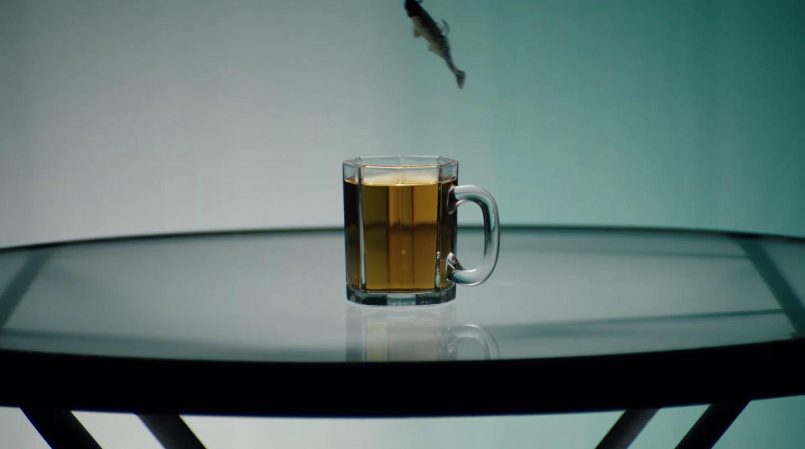 a glass of beer sitting on top of a table