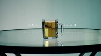a glass of tea sitting on top of a table