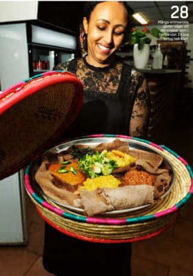 a woman holding a plate of food in her hands