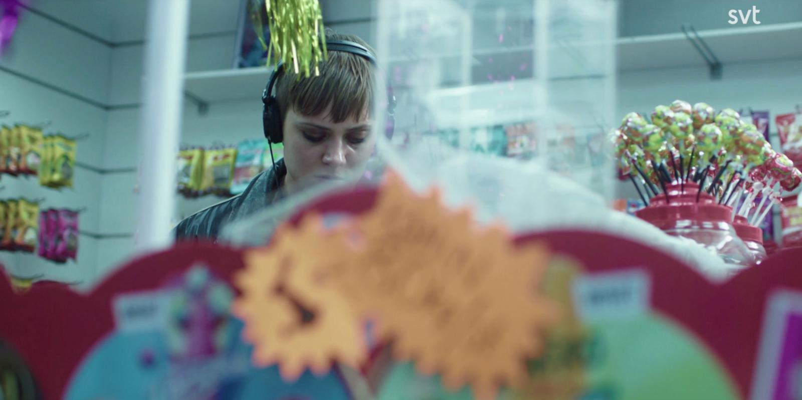 a man wearing headphones looking at a mirror