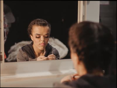 a woman looking at her reflection in a mirror