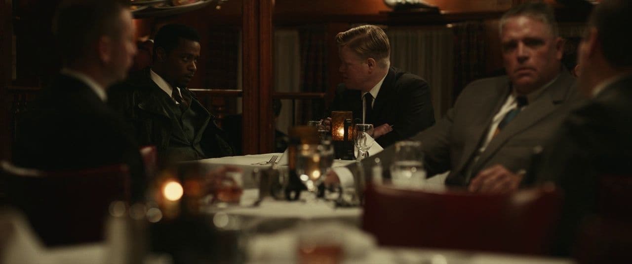 a group of people sitting around a dinner table