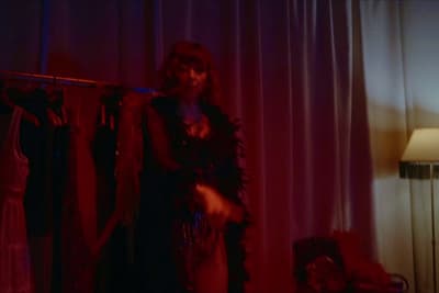 a woman standing in front of a red light