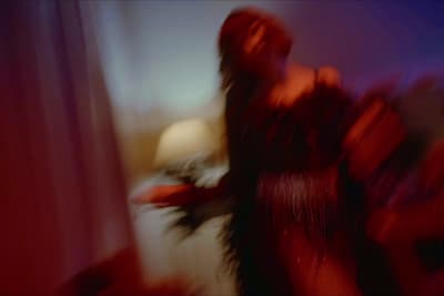 a blurry image of a woman in a red dress