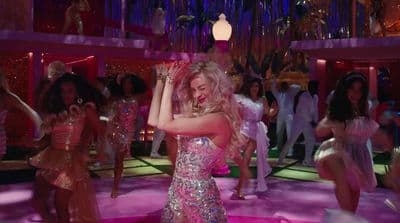 a woman in a pink dress dancing on a dance floor