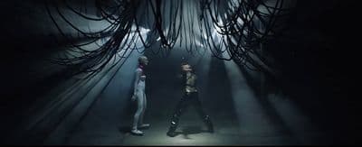 a couple of people standing in a dark room