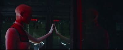 a man and a woman standing in front of a mirror