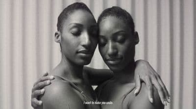two black women with their arms around each other