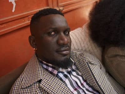 a man with an afro sitting next to a woman
