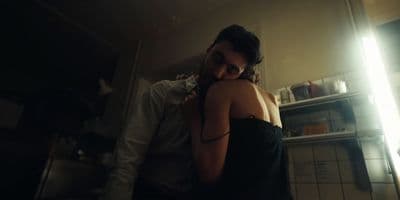 a man standing next to a woman in a kitchen