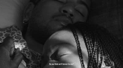 a black and white photo of a man and a woman sleeping