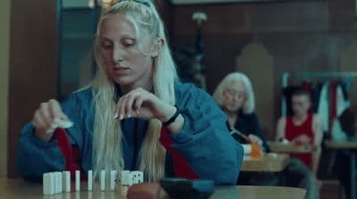 a woman sitting at a table in a restaurant